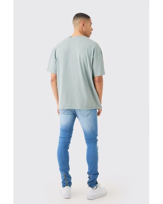 BoohooMAN Skinny Stretch Stacked Ripped Carpenter Zip Hem Jeans In Light Blue for men
