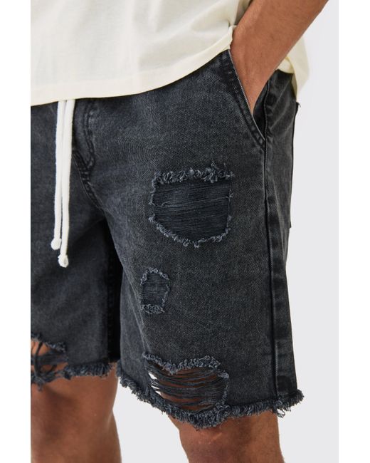 BoohooMAN Relaxed Rigid Elasticated Waist Ripped Denim Short In Washed Black for men