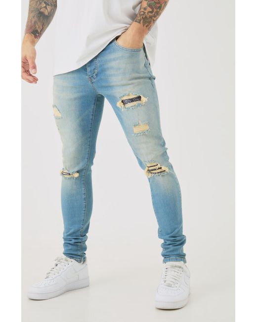 BoohooMAN Skinny Stretch Ripped Bandana Jeans In Light Blue for men