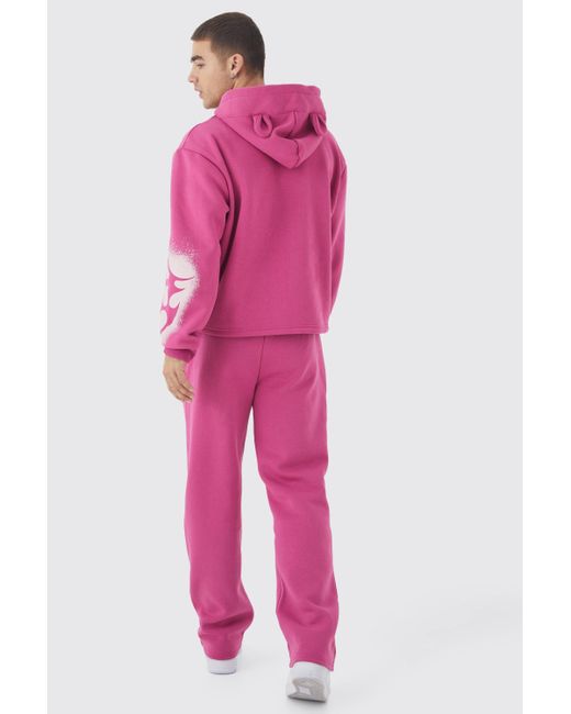 BoohooMAN Kastiger Oversize Trainingsanzug mit Graffiti-Ohren in Pink für Herren