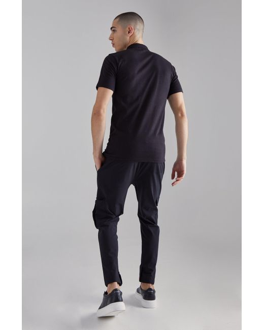 BoohooMAN Slim-Fit Poloshirt mit Man-Stickerei in Black für Herren
