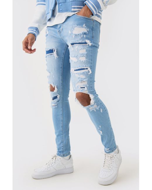 BoohooMAN Skinny Stretch All Over Rip Bleached Denim Jean In Light Blue for men