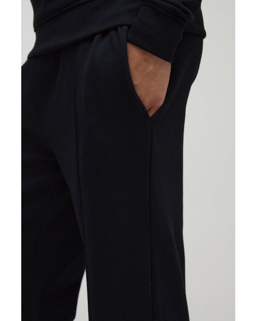 BoohooMAN Lockere Jogginghose mit geteiltem Saum in Black für Herren
