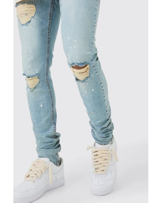 BoohooMAN Skinny Stretch Stacked Ripped Paint Splatter Jeans In Ice Blue for men