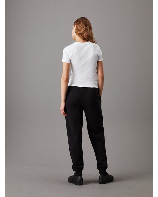 Pantalon de jogging relaxed en polaire avec monogramme Calvin Klein en coloris Black