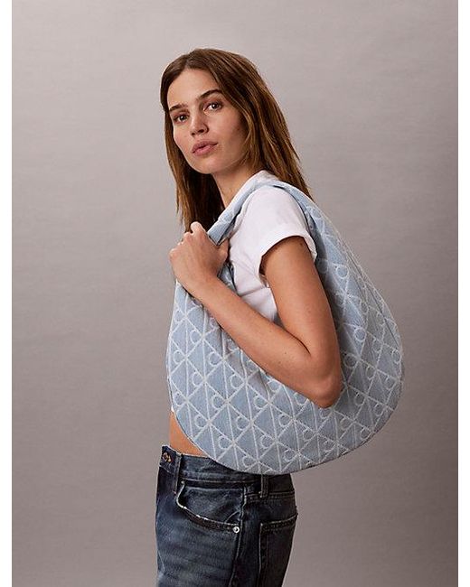 Calvin Klein Blue Allover Emblem Logo Denim Crescent Bag