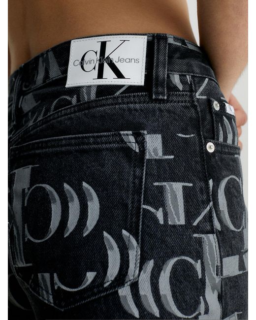 Jean droit entièrement imprimé de logos Calvin Klein en coloris Black
