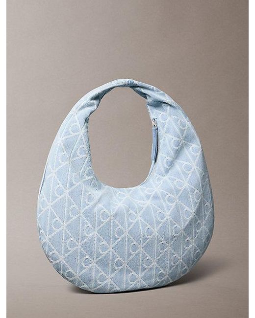 Calvin Klein Blue Allover Emblem Logo Denim Crescent Bag