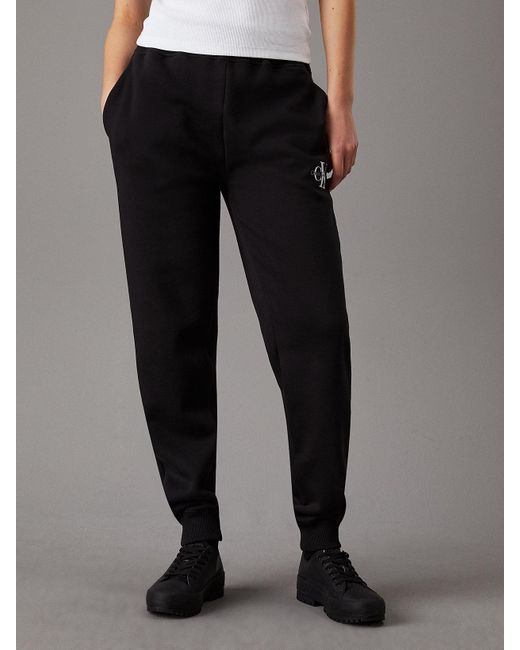 Pantalon de jogging relaxed en polaire avec monogramme Calvin Klein en coloris Black
