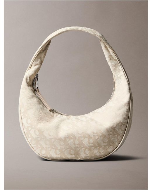 Calvin Klein Natural Calvin Klein Allover Monogram Logo Crescent Shoulder Bag