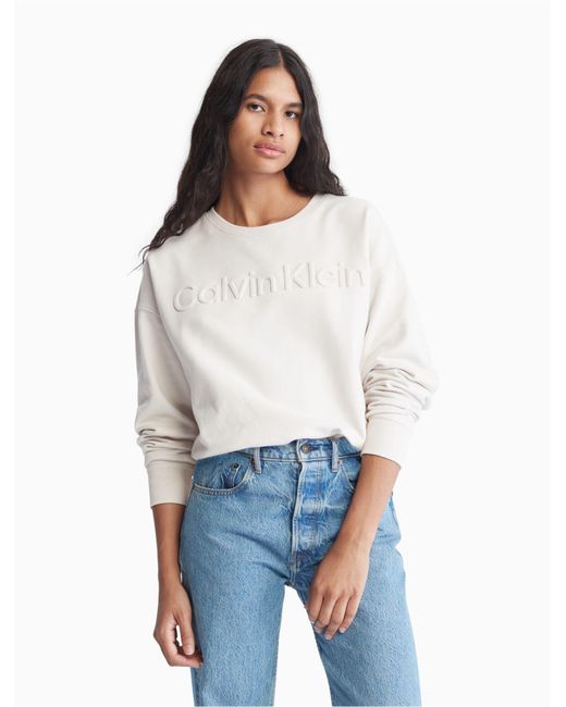 Calvin Klein Oversized Embossed Logo Crewneck Sweatshirt in White | Lyst  Canada