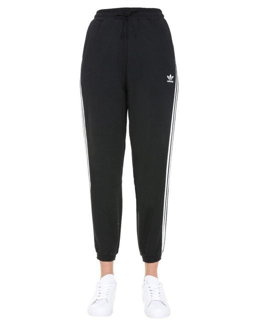 https://cdna.lystit.com/520/650/n/photos/cettire/8b8e27f7/adidas-originals-Black-Side-Stripe-Jogging-Pants.jpeg