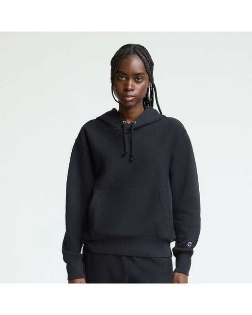 Black Champion Reverse Weave hoodie with drawcords and a sleeve C patch.