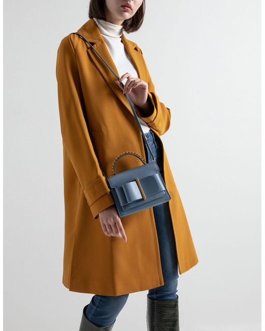 charles & keith chunky metal top handle bow flap bag