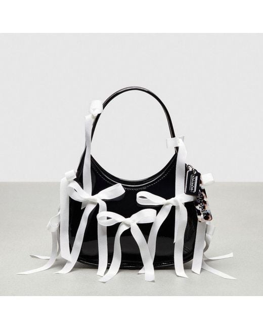 COACH Black Ergo Bag In Crinkle Patent Topia Leather With Bows All Over