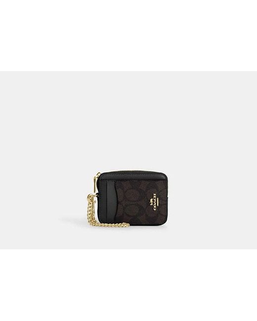 Tarjetero con cremallera en lona de firma COACH de color Black