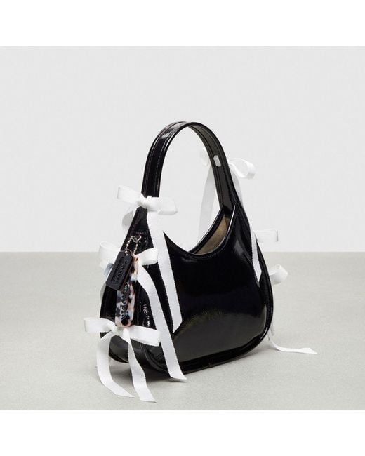COACH Black Ergo Bag In Crinkle Patent Topia Leather With Bows All Over