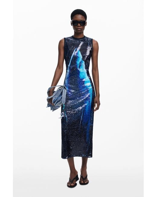 reversible sequin dress The Solen Dress features a reversible sequin drape layer, that can be styled at the front or back of the body. Available online now