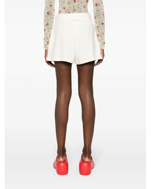 Pantalones cortos con logo triangular Prada de color White