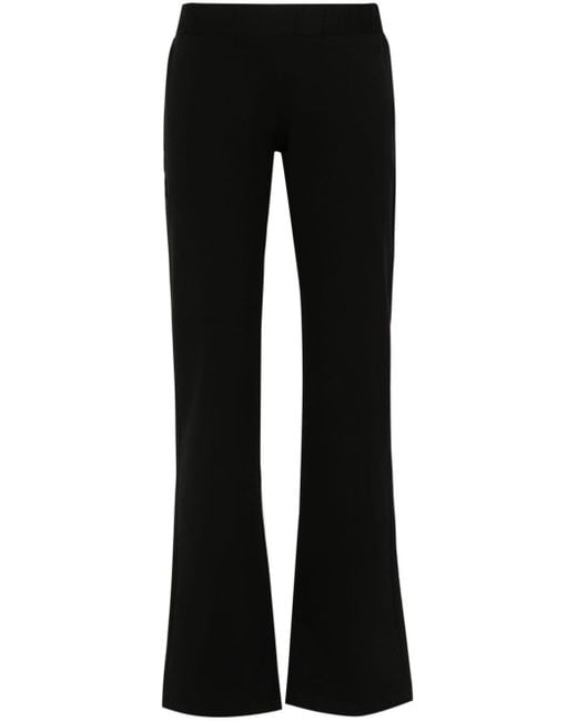 Pantaloni crop con logo in cristalli di Versace in Black