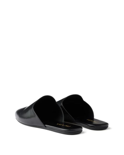 Mules Con Logo Goffrato di Prada in Black
