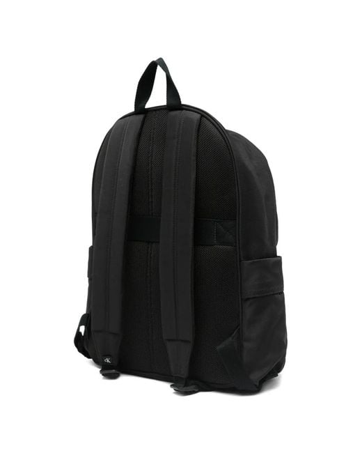 calvin klein leather round backpack Raised LV04D3155G This sleek Calvin Klein rucksack features an embossed monogram pattern and a top handle for a stylish Calvin Klein Nylon Round Backpack