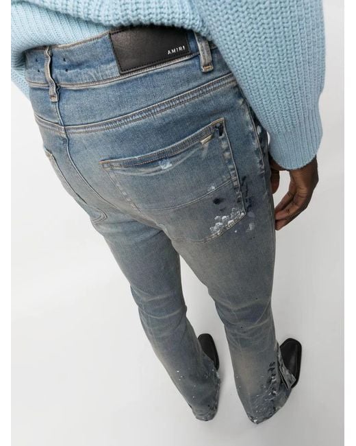Amiri Blue Paint-splattered Flared-leg Stretch-denim Jeans for men