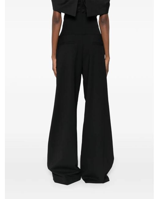 Pantalones ajustados con cremallera Thelatest de color Black