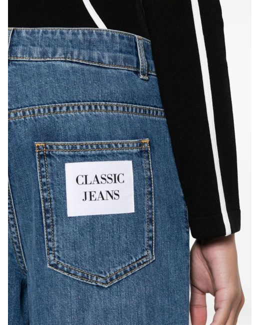 Jeans dritti a vita media di Moschino in Blue