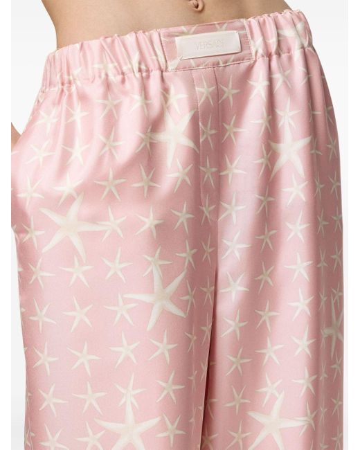 Pantalones fluidos con estampado de estrellas de mar Versace de color Pink