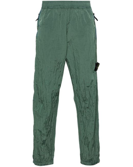 Pantalon de jogging fuselé à effet métallisé Stone Island pour homme en coloris Green