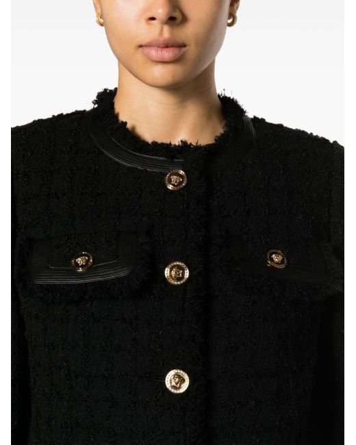 Veste crop en tweed à franges Versace en coloris Black