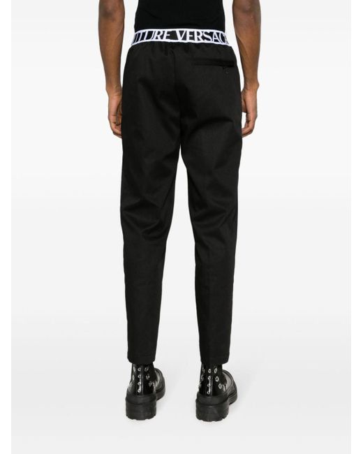 Pantalones con logo en la cinturilla Versace de hombre de color Black