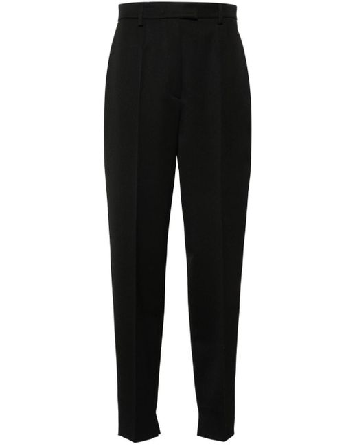 Pantaloni affusolati con pieghe di Prada in Black