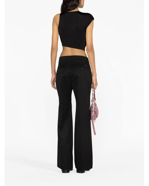 Pantalon en laine à coupe évasée Givenchy en coloris Black