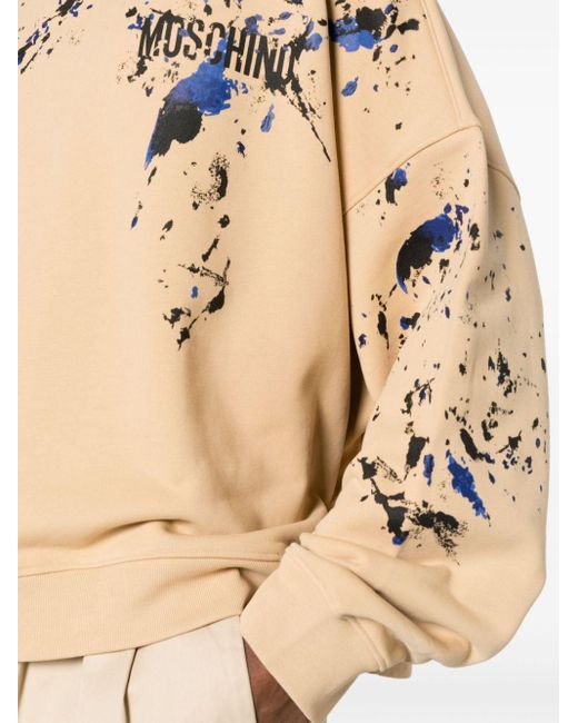 Moschino Sweater Met Logoprint En Verfspatten in het Natural voor heren