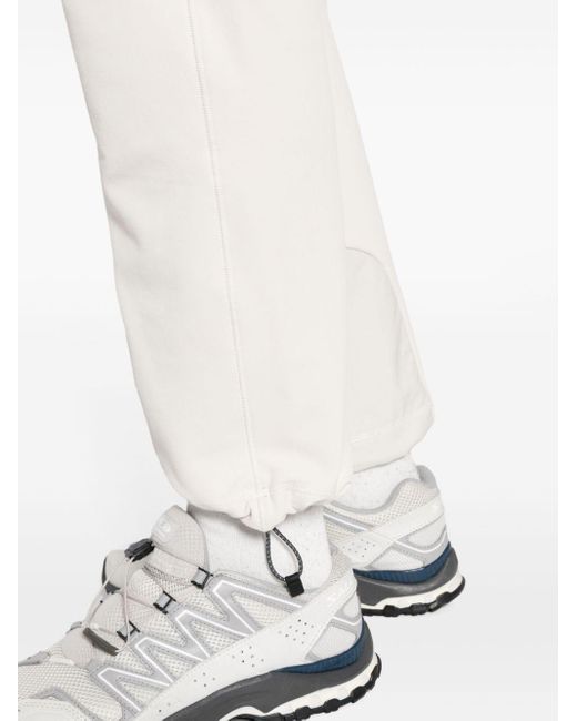 Pantalones impermeables con cinturón And Wander de hombre de color White