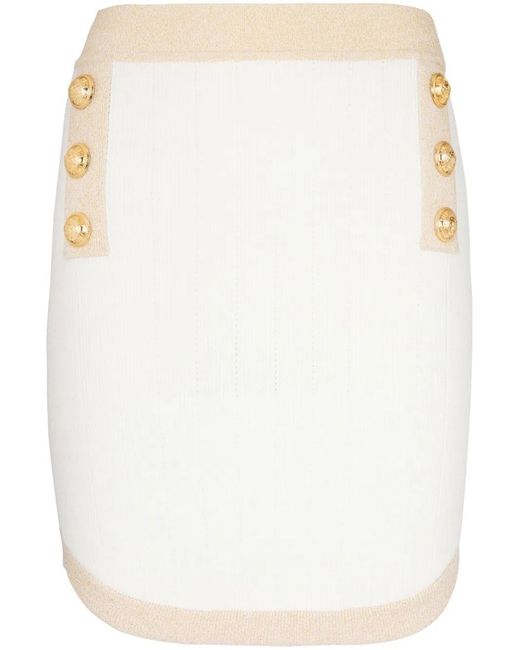 Minigonna bianca a matita con bottoni e finiture oro di Balmain in White