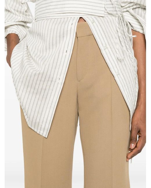 Totême Natural Kick Pressed-Crease Flared Trousers