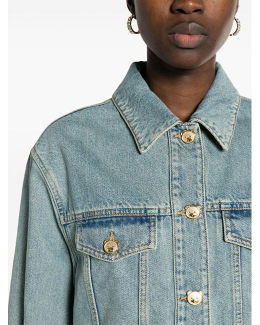 Veste en jean crop à boutons logo Moschino en coloris Blue