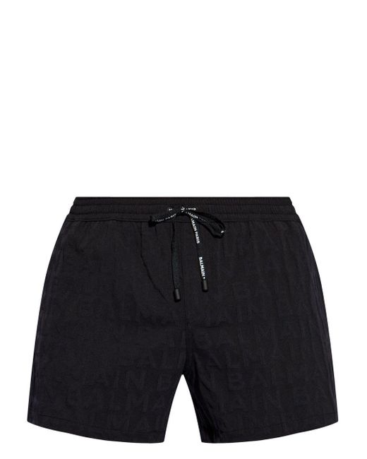 Shorts denim con logo goffrato di Balmain in Black da Uomo