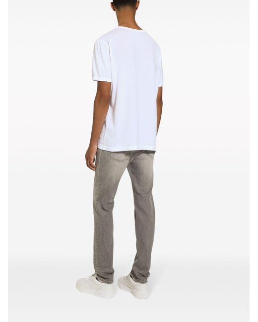Jeans slim con placca logo di Dolce & Gabbana in Gray da Uomo