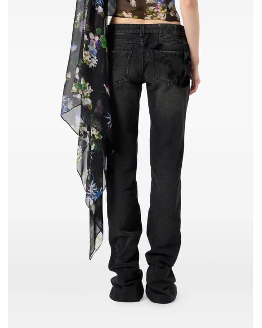 Vaqueros acampanados con aplique de mariposa Blumarine de color Black