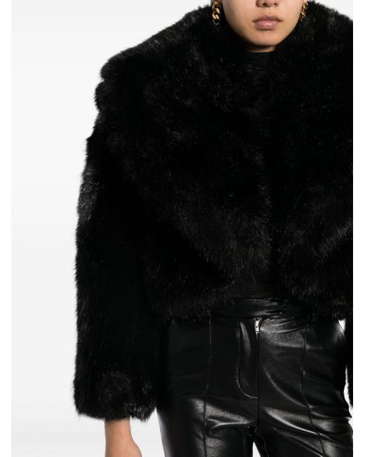 Veste en fourrure artificielle à capuche Versace en coloris Black