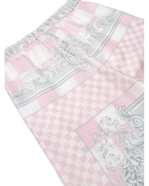 Pantalon évasé à imprimé graphique Versace en coloris White