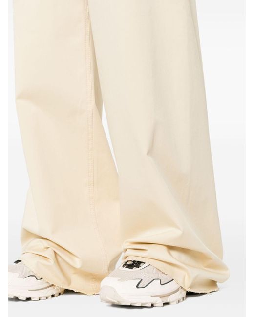 Pantaloni a gamba ampia con effetto vissuto di MM6 by Maison Martin Margiela in White