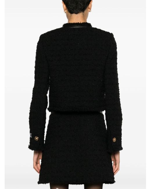 Veste crop en tweed à franges Versace en coloris Black