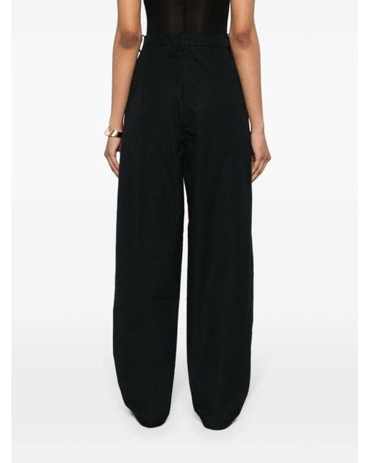 Pleat-detail cotton trousers Magda Butrym de color Black