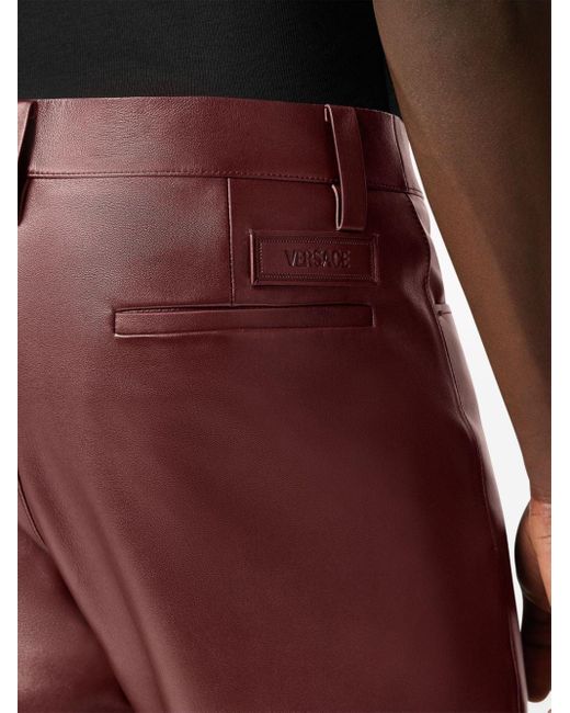 Pantalon évasé en cuir Versace pour homme en coloris Red