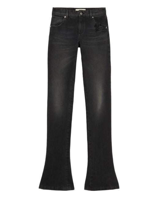 Vaqueros acampanados con aplique de mariposa Blumarine de color Black